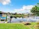 Picturesque waterfront with private dock, lush green lawn, and clear blue sky at 3723 Toulouse Ct, Punta Gorda, FL 33950