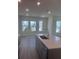 Bright kitchen featuring stainless steel appliances, a center island and gray cabinets at 160 Eagleston Ln, Lakewood Ranch, FL 34240