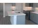 Modern kitchen featuring stainless steel appliances, a center island and gray cabinets at 160 Eagleston Ln, Lakewood Ranch, FL 34240