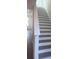 Stylish staircase featuring wood stairs and modern white railings at 160 Eagleston Ln, Lakewood Ranch, FL 34240