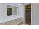 Bathroom with white vanity and a large mirror at 4571 Clearwater Harbor S Dr, Largo, FL 33770
