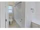 Bright bathroom with tile floors, walk-in shower, and white fixtures at 4571 Clearwater Harbor S Dr, Largo, FL 33770