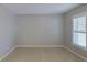 Well-lit bedroom featuring tile floors and plantation shutters at 4571 Clearwater Harbor S Dr, Largo, FL 33770