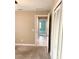 Bedroom with neutral carpet and louvered closet doors leading to a tiled hallway with a view of another room at 4571 Clearwater Harbor S Dr, Largo, FL 33770