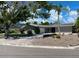 Lovely single-story home with a light grey exterior, palm tree, and brick-paved driveway at 4571 Clearwater Harbor S Dr, Largo, FL 33770