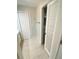 Hallway with tile floors, linen closet, and access to other areas of the home at 4571 Clearwater Harbor S Dr, Largo, FL 33770