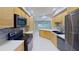 Renovated kitchen showcasing stainless steel appliances, tile floors and backsplash at 4571 Clearwater Harbor S Dr, Largo, FL 33770
