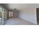 Bright living room with tile floors, ceiling fan, and sliding glass doors to the backyard at 4571 Clearwater Harbor S Dr, Largo, FL 33770