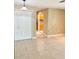 Neutral room featuring tile flooring and closet with peek into adjacent kitchen at 4571 Clearwater Harbor S Dr, Largo, FL 33770