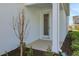 Side of the house with back door entry and a small patch of lush greenery at 130 Bragg Ln, Lakewood Ranch, FL 34240