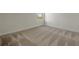 Bedroom with carpeted floors, white walls, and a bright window view at 130 Bragg Ln, Lakewood Ranch, FL 34240