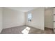 Bedroom with plush carpeting, white walls, and a window view of the neighborhood at 130 Bragg Ln, Lakewood Ranch, FL 34240