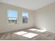 Bedroom with neutral carpet, white walls, and bright windows providing natural light at 130 Bragg Ln, Lakewood Ranch, FL 34240