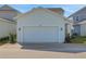 Charming home exterior with well-maintained lawn and a two-car garage at 130 Bragg Ln, Lakewood Ranch, FL 34240