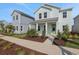 Charming two-story home with covered porch, landscaped front yard and light blue exterior at 130 Bragg Ln, Lakewood Ranch, FL 34240