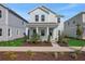 Charming two-story home with covered porch, landscaped front yard and light blue exterior at 130 Bragg Ln, Lakewood Ranch, FL 34240
