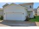 Charming home exterior with well-maintained lawn and a two-car garage at 130 Bragg Ln, Lakewood Ranch, FL 34240