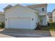 Charming home exterior with well-maintained lawn and a two-car garage at 130 Bragg Ln, Lakewood Ranch, FL 34240