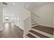 Bright foyer with hardwood floors, staircase and ample natural light from nearby windows at 130 Bragg Ln, Lakewood Ranch, FL 34240