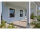 Inviting front porch features neutral concrete and white support columns at 130 Bragg Ln, Lakewood Ranch, FL 34240