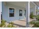 Inviting front porch features neutral concrete and white support columns at 130 Bragg Ln, Lakewood Ranch, FL 34240