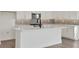 Modern kitchen island with white countertops, cabinets and stainless-steel appliances at 130 Bragg Ln, Lakewood Ranch, FL 34240