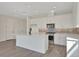 Modern kitchen features an island, stainless steel appliances, and stylish backsplash at 130 Bragg Ln, Lakewood Ranch, FL 34240