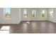 Bright living room with hardwood floors, natural light from many windows, and open space at 130 Bragg Ln, Lakewood Ranch, FL 34240