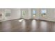 Open-concept living area with hardwood floors, large windows, and lots of natural light at 130 Bragg Ln, Lakewood Ranch, FL 34240