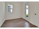 Room with wood-look flooring, white walls and trim, glass door to exterior at 130 Bragg Ln, Lakewood Ranch, FL 34240