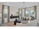 Bright and airy living room with modern decor, a stylish cabinet, and comfortable seating arrangements at 134 Bragg Ln, Lakewood Ranch, FL 34240