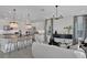 Spacious living area with modern furnishings, stylish lighting, and an open layout that connects to the kitchen at 134 Bragg Ln, Lakewood Ranch, FL 34240