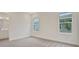 Bright bedroom with two windows and light gray carpet at 145 Thorne Ln, Lakewood Ranch, FL 34240