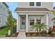Inviting front porch with a well-manicured lawn and lush landscaping creates a charming curb appeal at 145 Thorne Ln, Lakewood Ranch, FL 34240