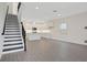 Open-concept living room with staircase adjacent to the kitchen at 145 Thorne Ln, Lakewood Ranch, FL 34240