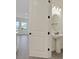 A half bathroom has a white pedestal sink with black fixtures near a door opening to the living room at 164 Eagleston Ln, Lakewood Ranch, FL 34240
