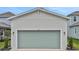 Two car garage with a green door on a new build home at 164 Eagleston Ln, Lakewood Ranch, FL 34240