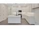 The kitchen features an island, stainless steel appliances, and sleek gray flooring at 164 Eagleston Ln, Lakewood Ranch, FL 34240
