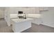 A modern kitchen features a center island, white cabinets, and stainless steel appliances at 164 Eagleston Ln, Lakewood Ranch, FL 34240