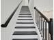 Staircase features dark wood trim and white risers leading to an upper floor at 164 Eagleston Ln, Lakewood Ranch, FL 34240