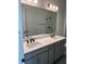 Bathroom featuring double sinks, a wide mirror, gray cabinetry, and a glass-enclosed shower at 172 Eagleston Ln, Lakewood Ranch, FL 34240