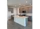 Modern kitchen featuring gray cabinetry, a center island with a sink, and stainless steel appliances at 172 Eagleston Ln, Lakewood Ranch, FL 34240