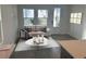 Cozy living room featuring light gray plank floors, a neutral sofa, and bright, natural light at 172 Eagleston Ln, Lakewood Ranch, FL 34240