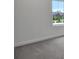Neutral carpeted bedroom featuring a window with a view of the outdoors at 204 Eagleston Ln, Lakewood Ranch, FL 34240