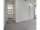 An open doorway from the bedroom leads to a bathroom with white cabinetry and gray wood-style flooring at 9035 Duany Ln, Lakewood Ranch, FL 34240