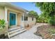 Tan house with teal door and landscaped walkway at 1701 38Th Ave, St Petersburg, FL 33713