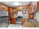 Kitchen with wood cabinets, granite countertops, and stainless steel appliances at 1701 38Th Ave, St Petersburg, FL 33713