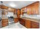 Kitchen boasts wood cabinets, granite countertops, and stainless steel appliances at 1701 38Th Ave, St Petersburg, FL 33713