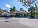 Community clubhouse with palm trees and ample parking at 13905 River Willow Pl, Tampa, FL 33637