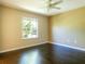 Spacious bedroom with dark hardwood floors and a large window at 13905 River Willow Pl, Tampa, FL 33637